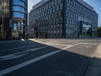 a very modern building with glass windows on either side, and bicycle lane on the right