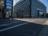 a very modern building with glass windows on either side, and bicycle lane on the right