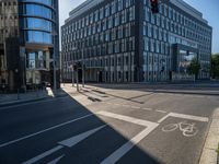 a very modern building with glass windows on either side, and bicycle lane on the right