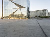 the building is built to look like a triangular triangle and sits on a stone patio