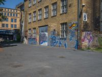 a parking lot in an abandoned city with graffiti on it, including windows, and a door