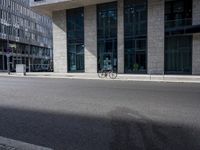 a bike in front of an office building and another building behind it with buildings on either side