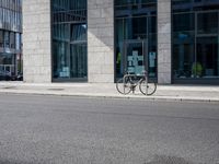 a bike in front of an office building and another building behind it with buildings on either side