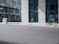 a bike in front of an office building and another building behind it with buildings on either side