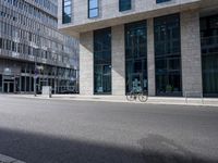 a bike in front of an office building and another building behind it with buildings on either side