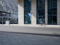 a bike in front of an office building and another building behind it with buildings on either side