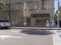 an image of people on the sidewalk in front of bulgaar in beverly hills