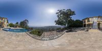 this is a fish eye photo of a house and pool in the hills around it