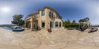 360 - angle of an outside patio view and the home from outside its private pool