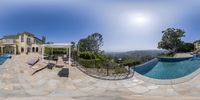 an aerial view of a pool and patio from the backyard yard of a home in beverly hills