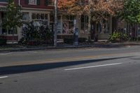 a person is riding a bicycle down a road while wearing safety clothing and holding up a street sign