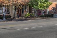 a person is riding a bicycle down a road while wearing safety clothing and holding up a street sign