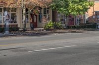 a person is riding a bicycle down a road while wearing safety clothing and holding up a street sign