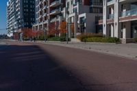 a bicycle sitting on the side of the road next to two tall buildings in the city