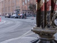 two rows of bicycles in front of an area covered by brick buildings and other buildings