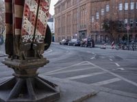 two rows of bicycles in front of an area covered by brick buildings and other buildings