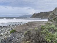 the coastline is rocky and grassy by the water's edge and an area with vegetation