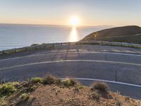 a curved road stretches the road along an ocean side road on a sunny day in a remote island