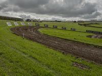 a man on a bike racing a course in the field for the race track with mud