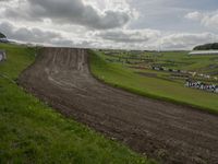 a man on a bike racing a course in the field for the race track with mud