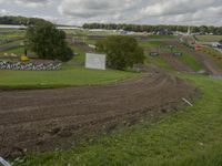a man on a bike racing a course in the field for the race track with mud