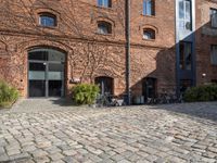 there are many bikes standing outside of this building in front of a door and some windows