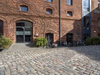 there are many bikes standing outside of this building in front of a door and some windows