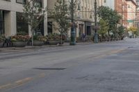 man on a bike riding down the street near buildings in an urban city setting with tall windows