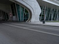 two people ride their bikes in front of the entrance to an airport terminal with tall windows