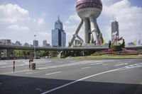 the man is riding his bike through the bridge, in front of oriental architecture and people walking