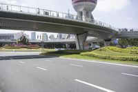 the man is riding his bike through the bridge, in front of oriental architecture and people walking