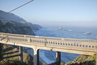 the bridge over the ocean is elevated and looks out to the beach and a sea