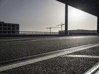 Black-and-white asphalt road surface under sunlight