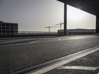 Black-and-white asphalt road surface under sunlight