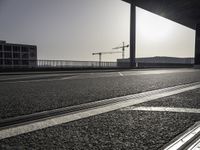 Black-and-white asphalt road surface under sunlight