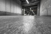 there is a black and white photo in the garage of a building with concrete flooring