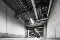 there is a black and white photo in the garage of a building with concrete flooring