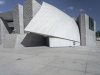 a black and white photograph of a building with large stones on the side and on top