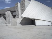 a black and white photograph of a building with large stones on the side and on top