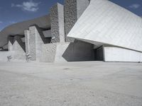 a black and white photograph of a building with large stones on the side and on top