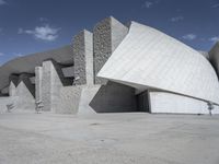 a black and white photograph of a building with large stones on the side and on top