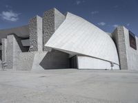 a black and white photograph of a building with large stones on the side and on top