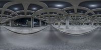 an image of a very high building with a curved corridor in front of it at night