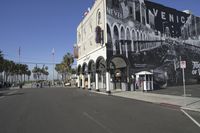 a building that has a black and white image on it on the side of the street