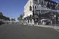 a building that has a black and white image on it on the side of the street