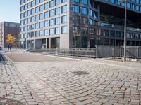 the large building is made of concrete and has metal railings around it, which are made of brick