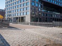 the large building is made of concrete and has metal railings around it, which are made of brick