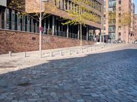 the large building is made of concrete and has metal railings around it, which are made of brick