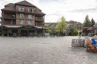 a blue chair is set on the square with the buildings behind it in front of them