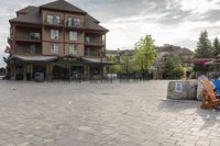 a blue chair is set on the square with the buildings behind it in front of them